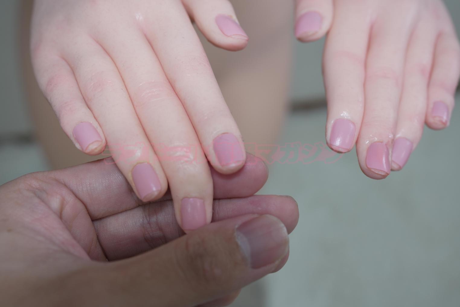 A close-up of a hand with painted nails, showing gentle skin texture, being held by a person's hand.