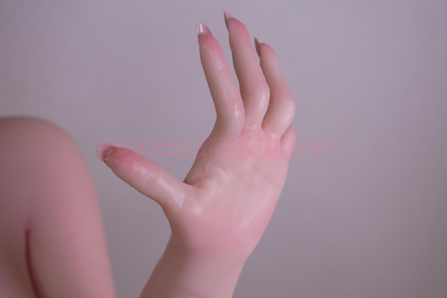Close-up of a realistic hand of a love doll, showcasing detailed skin texture and sculpting, including fingernails.