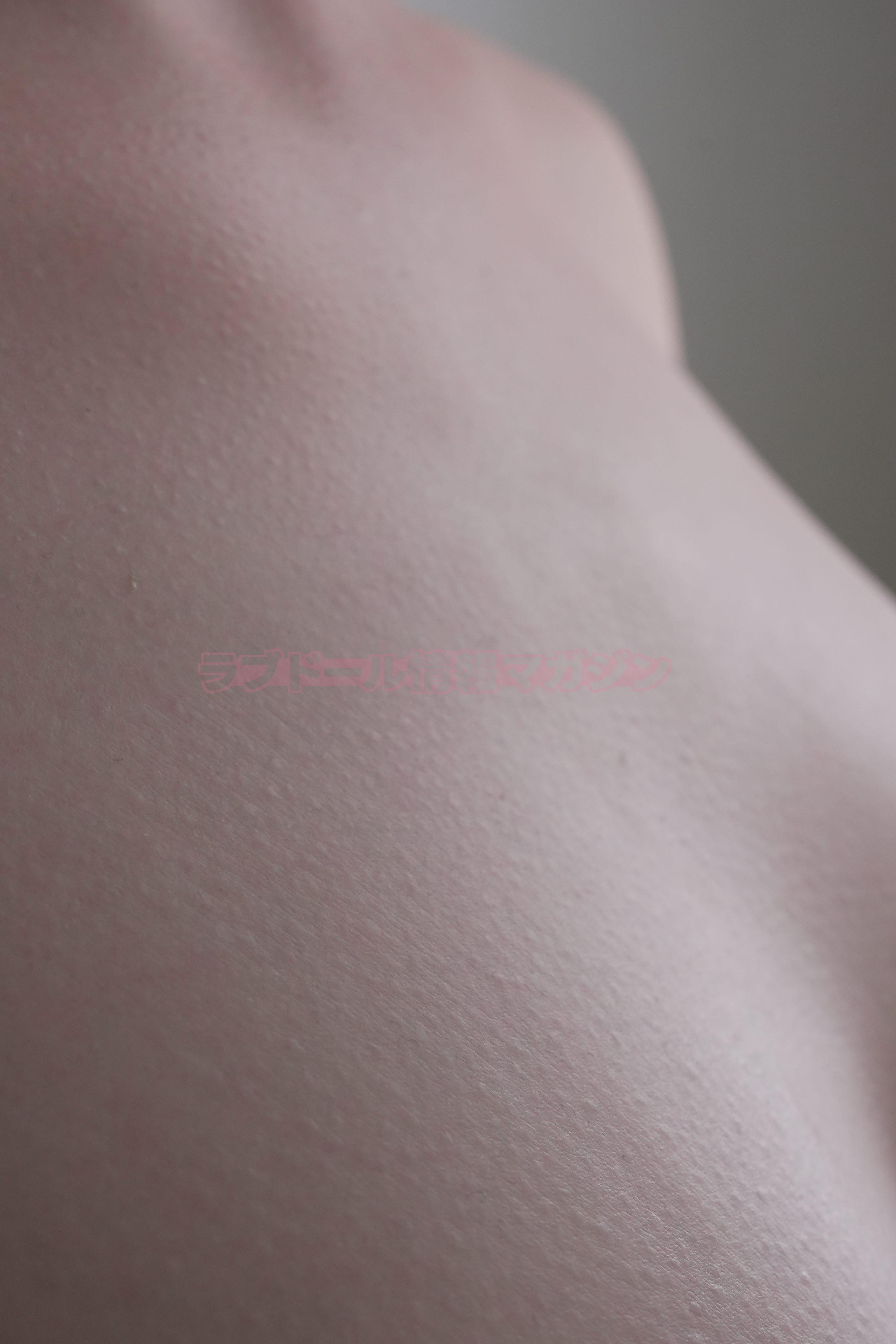 Close-up view of a realistic skin texture on a doll, showcasing softness and detail.