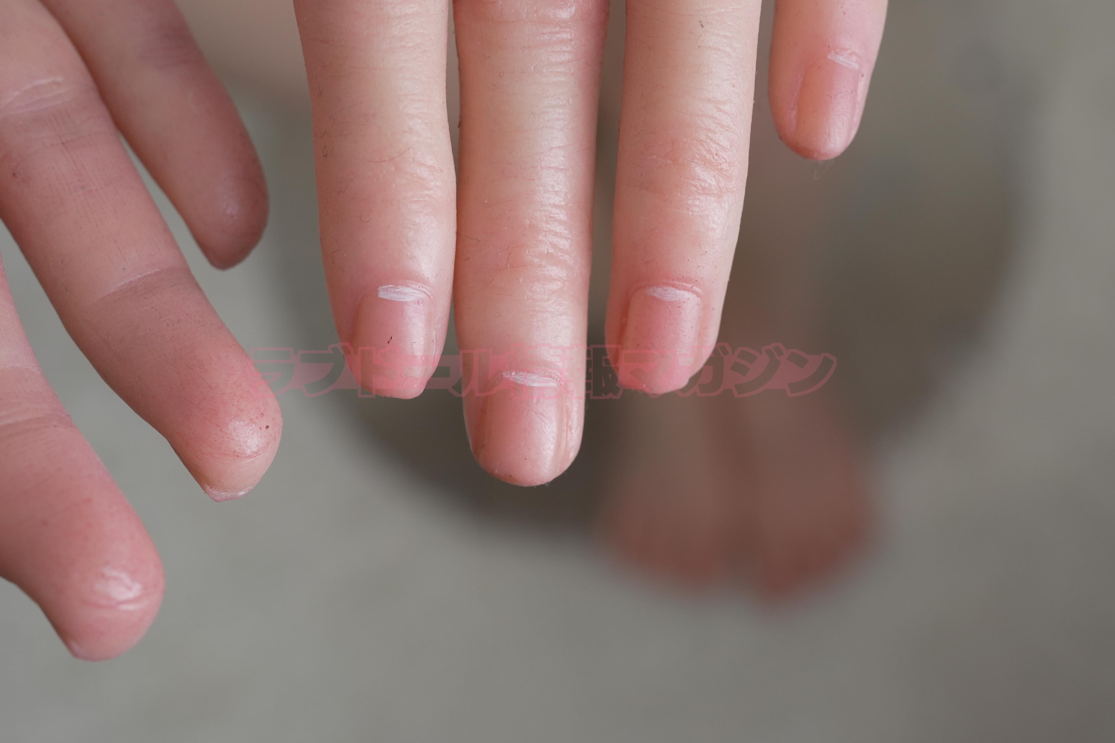Close-up of a pair of realistic-looking synthetic hands, showing detailed skin texture and nails.