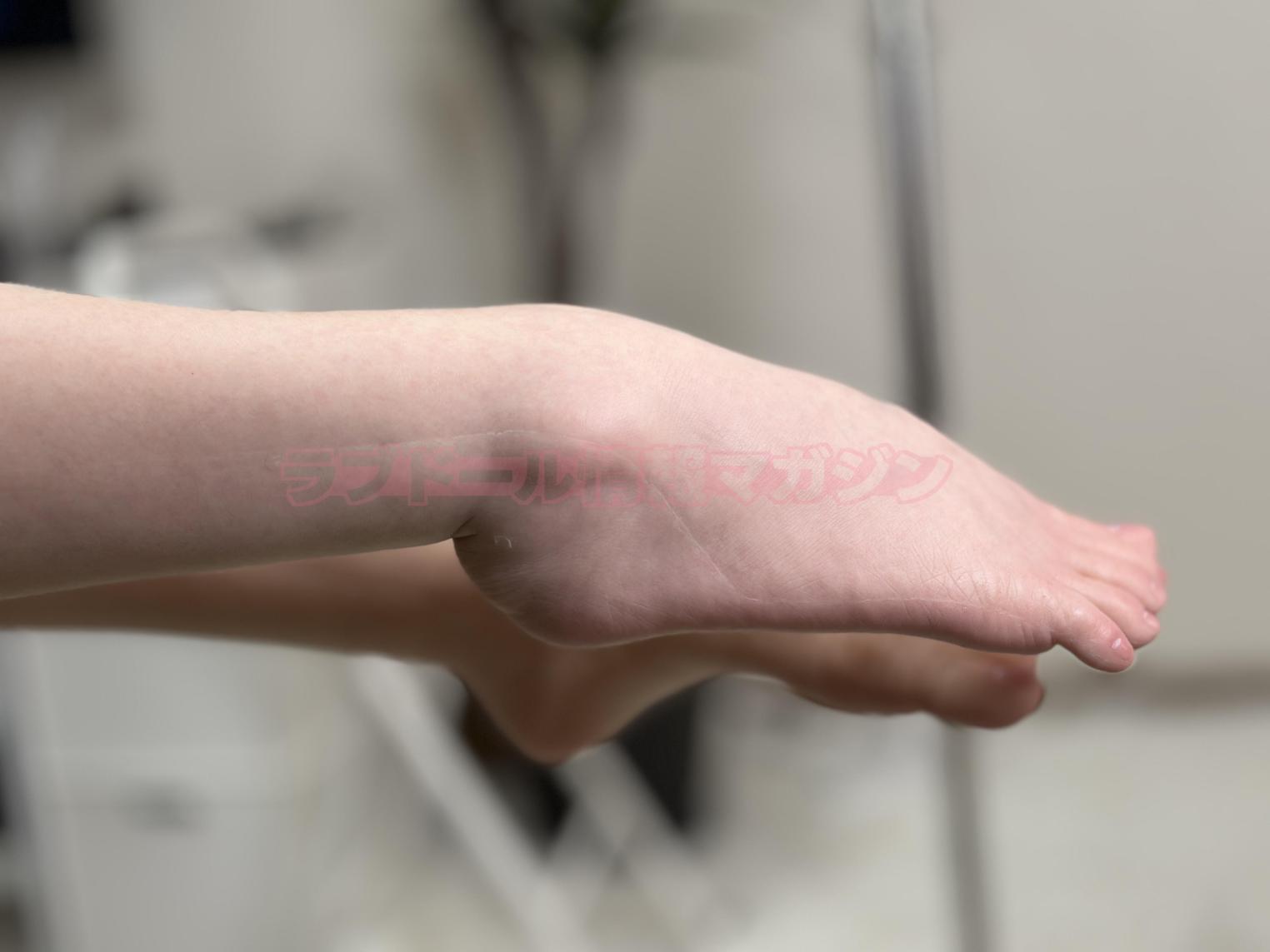 Close-up of a foot and ankle of a doll, showcasing realistic details and skin texture.